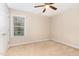 The bedroom offers a ceiling fan for comfort and a window allowing natural light into the space at 1952 Combine Cir, Apex, NC 27502