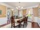 Elegant dining room with a chandelier, large windows, and hardwood floors at 1952 Combine Cir, Apex, NC 27502