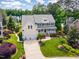 Aerial view of a two-story home with a two-car garage, front porch, and well-manicured lawn at 1952 Combine Cir, Apex, NC 27502