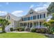Charming exterior view with a covered porch, manicured lawn, and lush landscaping at 1952 Combine Cir, Apex, NC 27502