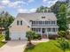 Charming two-story home with a welcoming front porch, beautiful landscaping, and a two car garage at 1952 Combine Cir, Apex, NC 27502