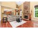 Inviting living room features a stone fireplace, hardwood floors, and a comfortable seating area at 1952 Combine Cir, Apex, NC 27502