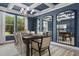 Elegant dining room with dark blue walls, a decorative chandelier, and a wooden table set for a dinner party at 199 Sugar Pine Drive, Franklinton, NC 27525