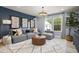 Comfortable living room with a gray sectional sofa, accent pillows, an interesting chandelier, and a large patterned rug at 199 Sugar Pine Drive, Franklinton, NC 27525