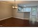 Open dining area with modern chandelier and hardwood floors, leading to the kitchen at 210 Standish Dr Dr, Chapel Hill, NC 27517