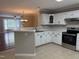 Bright kitchen with white cabinets and countertops, stainless steel appliances, and tile flooring at 210 Standish Dr Dr, Chapel Hill, NC 27517