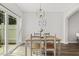 Cozy dining area with modern chandelier and sliding glass doors to the backyard at 223 Morgan Brook Way, Rolesville, NC 27571