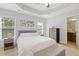 Serene bedroom featuring a tray ceiling, neutral colors, and ample natural light at 223 Morgan Brook Way, Rolesville, NC 27571