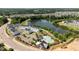 Aerial view of community buildings next to a pond, walking trails and a community pool at 236 Artisan Park Dr, Wake Forest, NC 27587