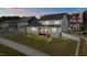 Backyard view of a two-story home featuring a wooden deck, privacy fence, and well-maintained lawn at 236 Artisan Park Dr, Wake Forest, NC 27587