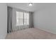 Neutral bedroom with a window dressed in long curtains allowing for plenty of natural light at 236 Artisan Park Dr, Wake Forest, NC 27587