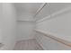 Walk-in closet with carpeted floor and wooden racks and shelving for plenty of storage at 236 Artisan Park Dr, Wake Forest, NC 27587