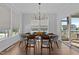 Bright dining room features stylish chandelier, wood floors, and large windows providing natural light at 236 Artisan Park Dr, Wake Forest, NC 27587
