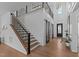 Grand entryway with hardwood floors, a staircase with black iron balusters and sliding barn doors at 236 Artisan Park Dr, Wake Forest, NC 27587
