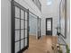 Elegant foyer showcasing hardwood floors, barn doors, and wainscotting, leading to an open floor plan at 236 Artisan Park Dr, Wake Forest, NC 27587