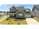 Charming two-story home features a welcoming front porch, well-kept lawn, and a two-car garage at 236 Artisan Park Dr, Wake Forest, NC 27587
