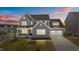 Beautiful two-story home boasts gray brick and siding, manicured landscaping, and an attached two-car garage at 236 Artisan Park Dr, Wake Forest, NC 27587
