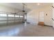 View of three car garage with epoxy flooring, painted walls and stairs to access door at 236 Artisan Park Dr, Wake Forest, NC 27587