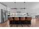 Modern kitchen with a large island with seating, stainless steel appliances, and pendant lighting at 236 Artisan Park Dr, Wake Forest, NC 27587