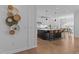 Gourmet kitchen featuring a large center island with bar seating, stainless appliances, and hardwood floors at 236 Artisan Park Dr, Wake Forest, NC 27587