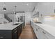 Modern kitchen features white cabinets, stainless steel appliances, and a large island with white countertops at 236 Artisan Park Dr, Wake Forest, NC 27587