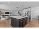 Open concept kitchen and living room with island, stainless steel appliances, and modern fixtures at 236 Artisan Park Dr, Wake Forest, NC 27587