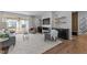 Open-concept living room with a marble fireplace, built-in cabinets, and access to a balcony at 236 Artisan Park Dr, Wake Forest, NC 27587