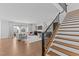 Bright living room featuring a fireplace, large windows, and hardwood floors; staircase in foreground at 236 Artisan Park Dr, Wake Forest, NC 27587