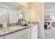 Bathroom featuring a granite countertop with dual sinks and a view into the well appointed bedroom at 24 Grove Township Way, Angier, NC 27501