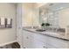 Bathroom featuring a granite countertop with dual sinks and white cabinets, offering ample storage space at 24 Grove Township Way, Angier, NC 27501