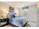 Comfortable bedroom with a black iron bed frame, complemented by a window and stylish decor at 24 Grove Township Way, Angier, NC 27501