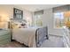 Bedroom featuring a comfortable bed, striped bedding, and natural light creating a calming retreat at 24 Grove Township Way, Angier, NC 27501