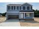 Charming two-story home featuring a spacious two-car garage and classic architectural design at 24 Grove Township Way, Angier, NC 27501