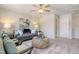 Bright living room with gray sofa, chairs, and a round wicker coffee table, creating an inviting atmosphere at 24 Grove Township Way, Angier, NC 27501