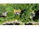 An aerial view showcases the property nestled among lush green trees with a long driveway at 25 Ballinger Dr, Youngsville, NC 27596