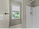 Bright bathroom featuring a shower with white tiling, window and updated fixtures at 25 Ballinger Dr, Youngsville, NC 27596