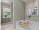 Bathroom featuring tub with wine, and natural light from two windows at 25 Ballinger Dr, Youngsville, NC 27596