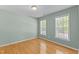Neutral bedroom with hardwood floors and two windows, providing ample natural light at 25 Ballinger Dr, Youngsville, NC 27596