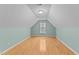 Upstairs bedroom with hardwood floors and a window in the unique shaped room at 25 Ballinger Dr, Youngsville, NC 27596