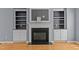 Living room with a fireplace, built-in bookcases and hardwood floors at 25 Ballinger Dr, Youngsville, NC 27596
