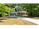 Inviting two-story home with blue shutters, a welcoming front porch, and a spacious driveway at 25 Ballinger Dr, Youngsville, NC 27596