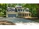 Inviting two-story home with blue shutters, a welcoming front porch, and a spacious driveway at 25 Ballinger Dr, Youngsville, NC 27596