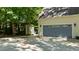Spacious two-car garage with a shed in the backyard, providing ample storage at 25 Ballinger Dr, Youngsville, NC 27596