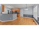 Bright kitchen boasts wood floors, stainless appliances, and wood cabinets at 25 Ballinger Dr, Youngsville, NC 27596