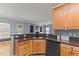 Open kitchen area featuring wooden cabinets, granite countertops, stainless steel appliances, and hardwood flooring at 25 Ballinger Dr, Youngsville, NC 27596