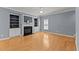 Living room with a fireplace, built-in bookcases, hardwood floors, and a ceiling fan at 25 Ballinger Dr, Youngsville, NC 27596