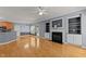 Open living room boasts a fireplace, built-in shelves, access to the backyard, and hardwood floors at 25 Ballinger Dr, Youngsville, NC 27596