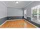 Bright living room showing neutral wall paint, light hardwood floors and updated windows at 25 Ballinger Dr, Youngsville, NC 27596