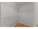 Spacious walk-in closet with white wire shelving and wooden floors at 25 Ballinger Dr, Youngsville, NC 27596