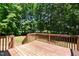 Private wooden deck surrounded by lush trees, offering a serene outdoor space at 25 Ballinger Dr, Youngsville, NC 27596